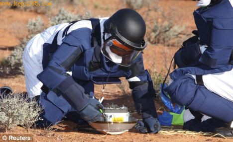 A scientist carefully disconnects part of the Hayabusa space capsule in the Australian outback. The Japanese mission landed on an asteroid to collect samples of space rock
